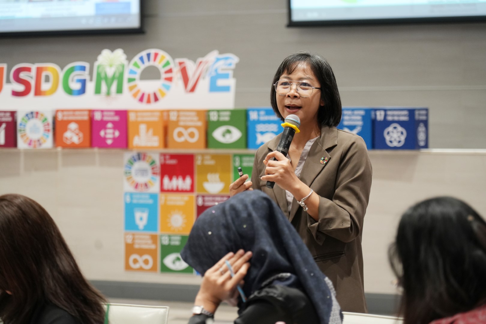 A speaker presenting at an SDGs workshop at Walailak University.